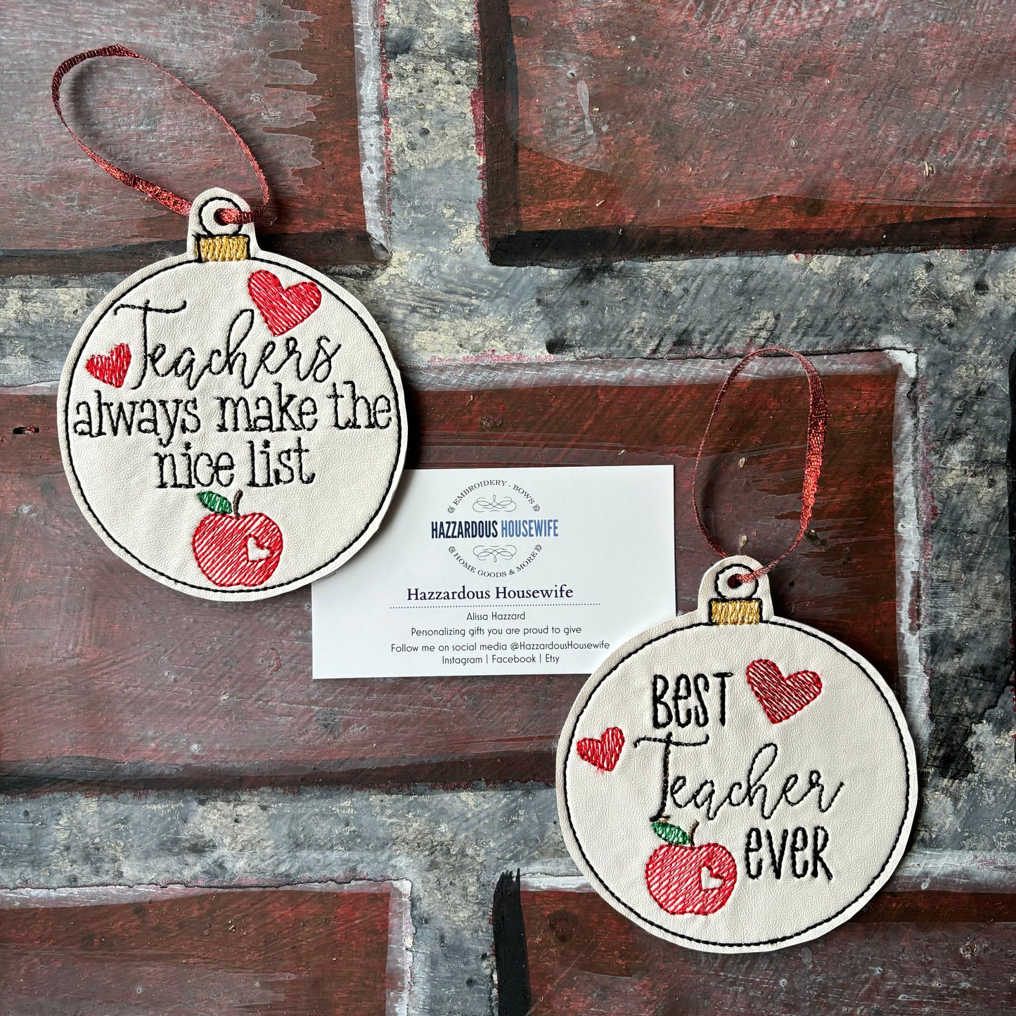 Two round wooden ornaments with text and red apples on a rustic wooden background.