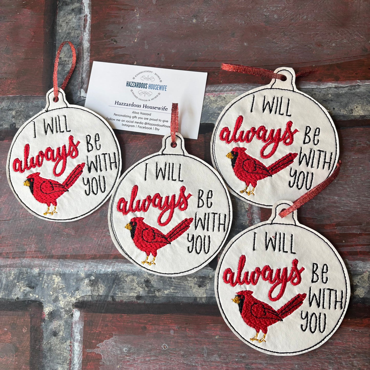 Four circular ornaments with red cardinals and text on a wooden background