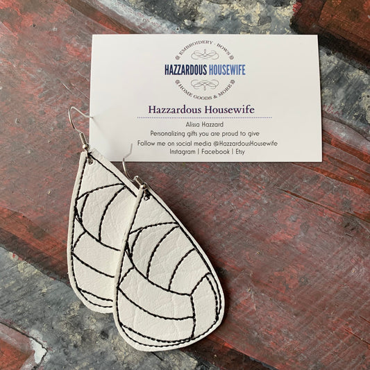 Leather Volleyball earrings with geometric design on a card featuring 'Hazzardous Housewife' branding.