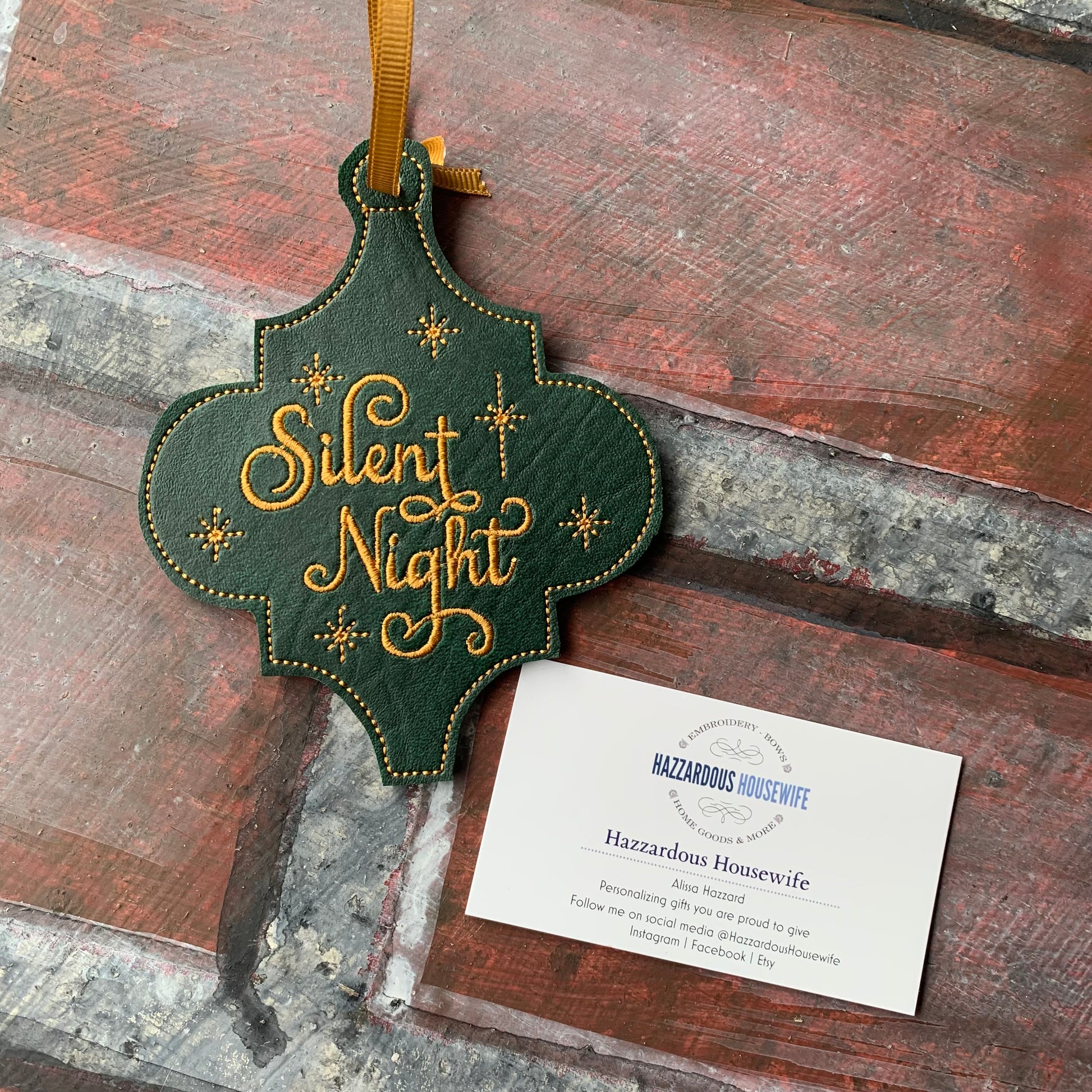 Decorative ornament with 'Silent Night' text on a wooden surface