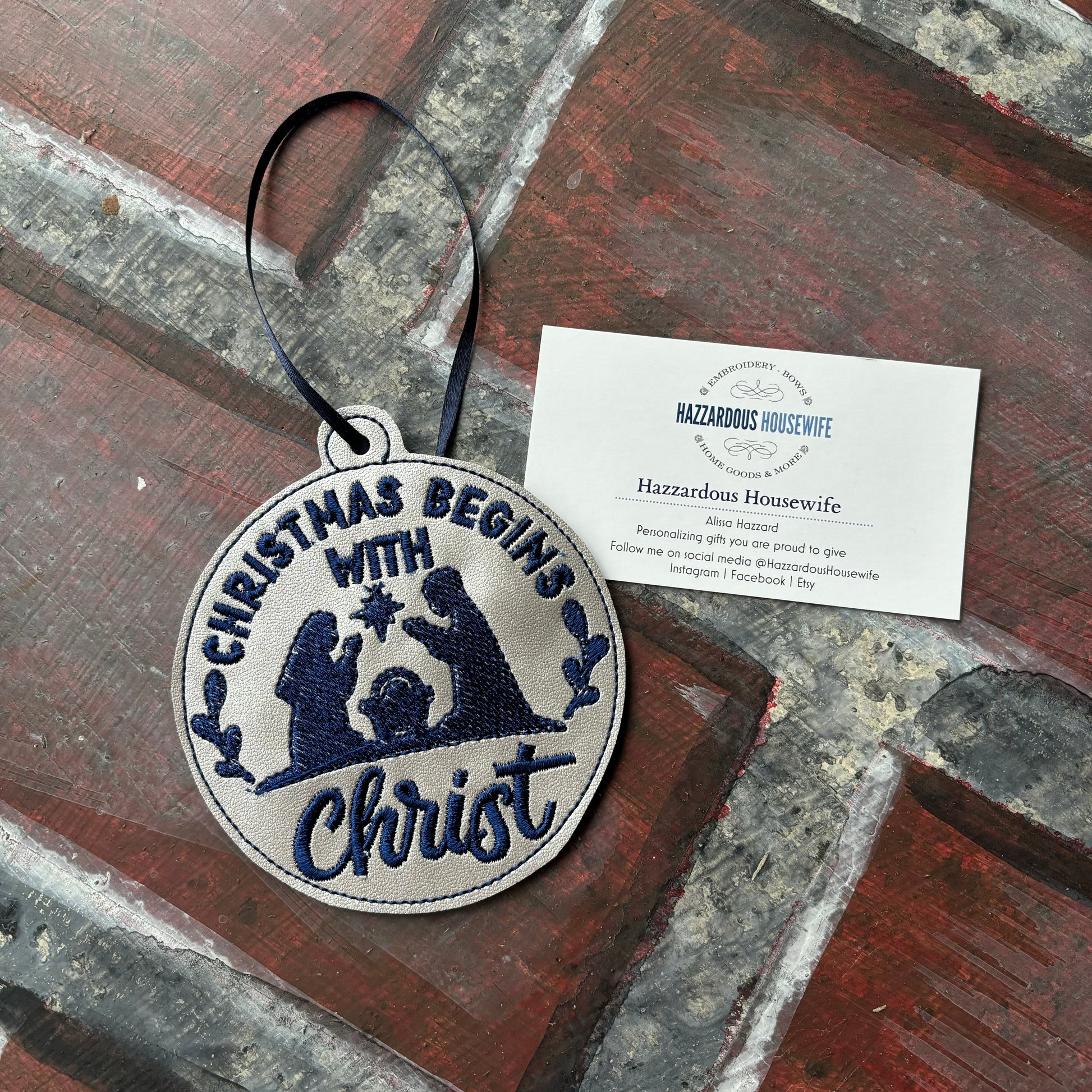 Decorative patch with 'Christmas Begins with Christ' text and nativity scene on a rustic surface.