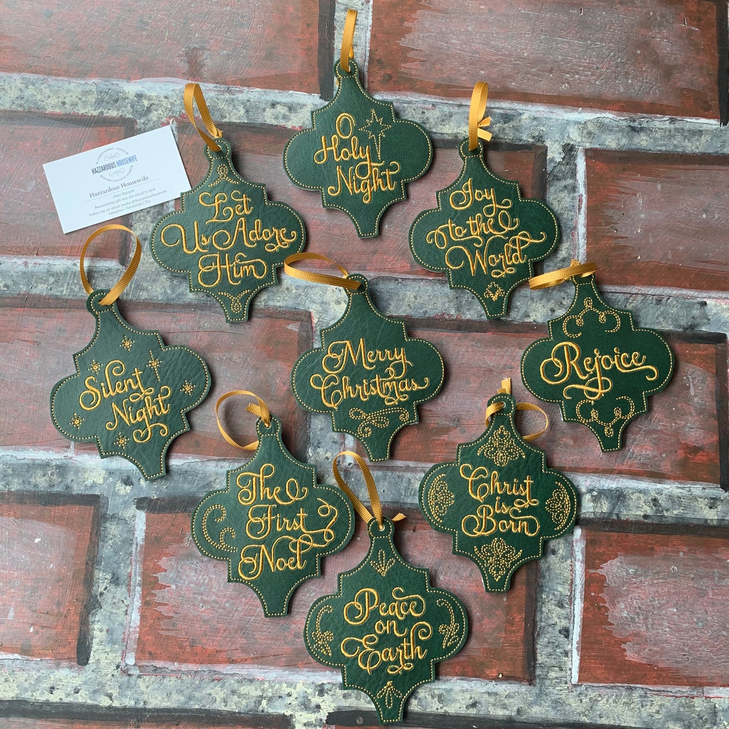 Set of green and gold Christmas ornaments with festive phrases on a rustic wooden background.